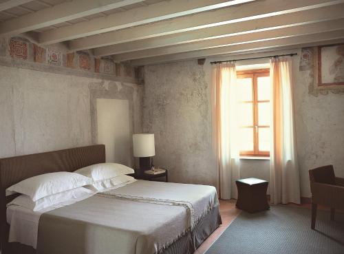 a bedroom with a large bed and a window at Villa Arcadio in Salò