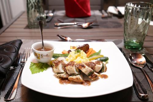 a plate of food with meat and vegetables on a table at Serendib Signature Resort in Digana