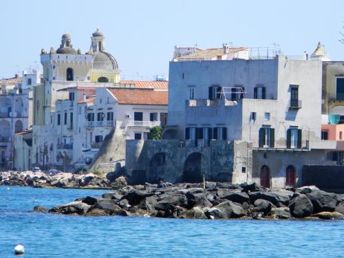 a group of buildings next to the water at Parco Aurora Terme in Ischia