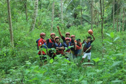 a group of people posing for a picture in the forest at Jelajah Batukaras in Batukaras