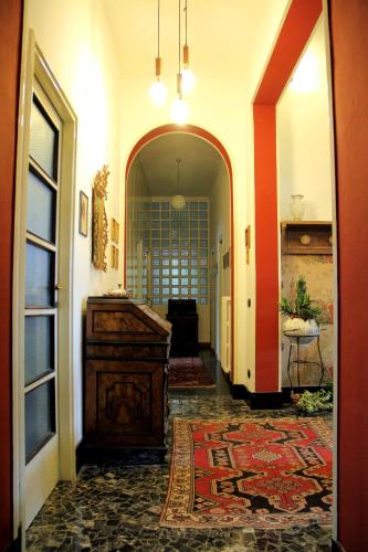 a hallway with an entry way with a large rug at Villa Adele in Varese