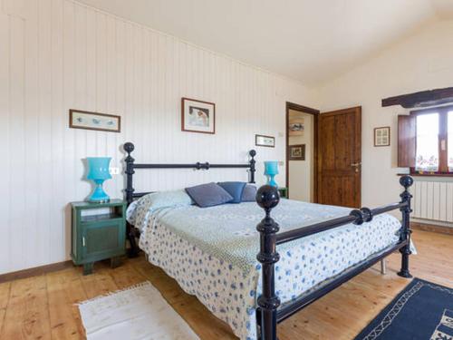 a bedroom with a bed with blue pillows on it at Private pool Villa Wine&cooking -Trasimeno Lake in Panicale