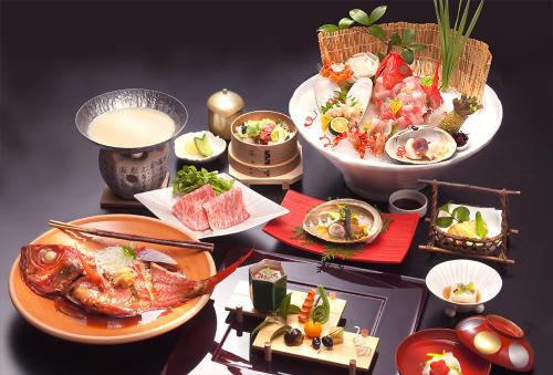 a table topped with plates of food and bowls of food at 旅館かわな -Ryokan Kawana- in Kimitsu