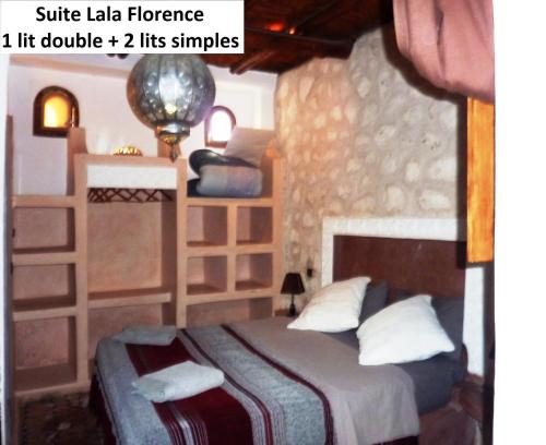 a bedroom with a bed in a room with a wall at Villa Grenadine in Essaouira