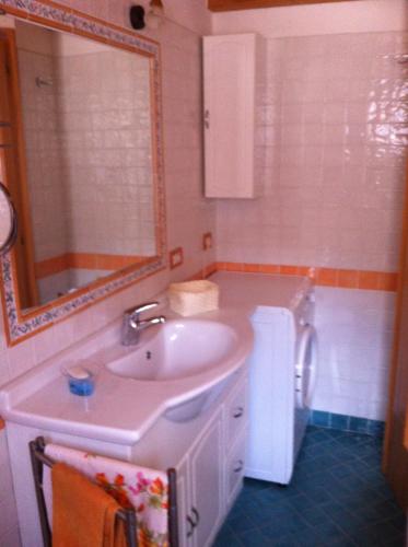 a bathroom with a sink and a mirror at Appartamento Ivo in Campitello di Fassa