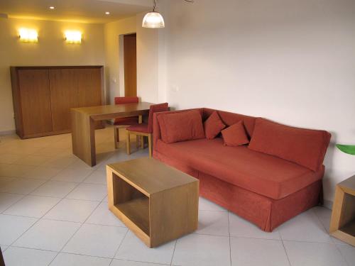 a living room with a couch and a table at Ohtels Campo De Gibraltar in La Línea de la Concepción