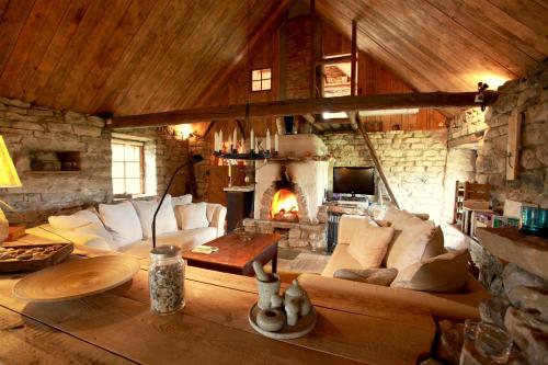 a living room with a couch and a fireplace at Metsara B & B in Tornimäe
