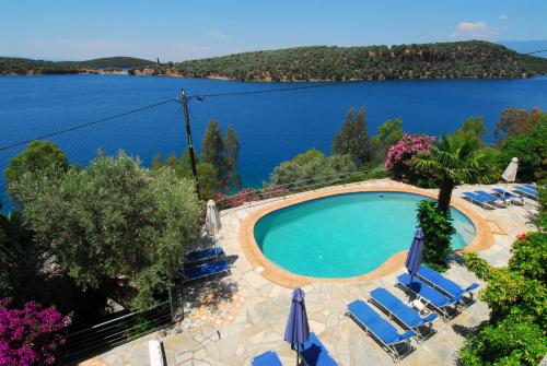 a swimming pool with a view of a lake at Dimitra Apartments in Milína