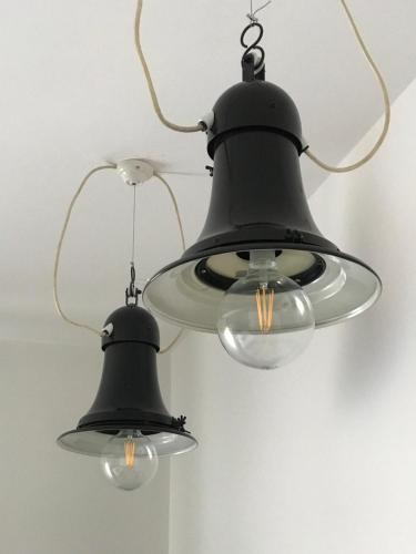 two black lights hanging from a ceiling at Hotel Miramonti in Schio