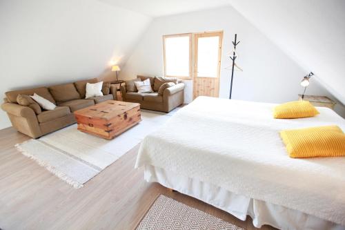 a bedroom with a large bed and a couch at Metsara B & B in Tornimäe