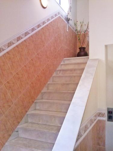 a staircase in a house with brown tiles at Aqui Jardim in Reguengos de Monsaraz