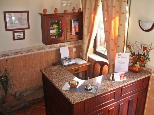 a kitchen with a counter with a phone on it at Aqui Jardim in Reguengos de Monsaraz