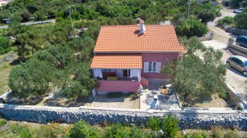 a small house with an orange roof on a hill at House Dorita in Miholašćica