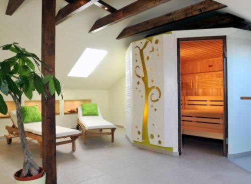 a room with a bedroom with a bed and a plant at Landhaus Heidehof in Dippoldiswalde