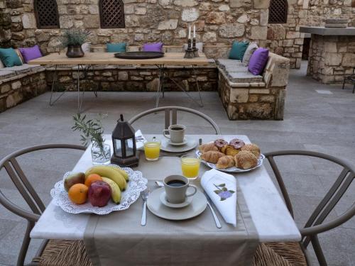 a table with fruit and coffee on a patio at Trinity Boutique Hotel in Rhodes Town