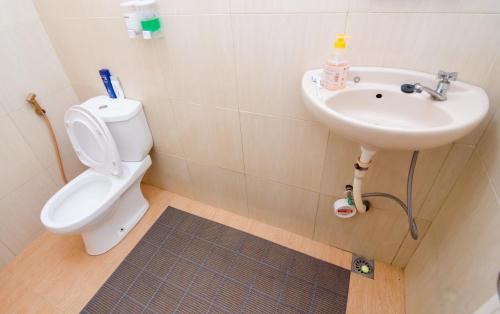 a bathroom with a toilet and a sink at Pendopo Andari Homestay in Yogyakarta