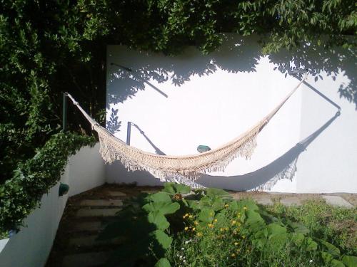 a hammock hanging on the side of a wall at Casa Amarante Porto in Amarante