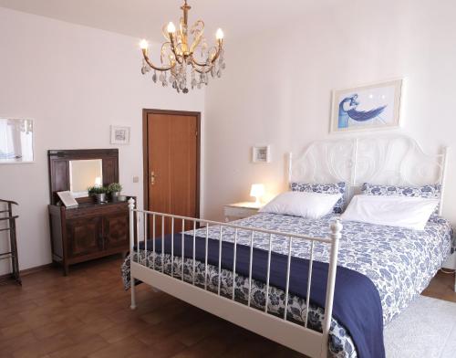 a bedroom with a bed and a chandelier at Goga&Romeo in Pesaro