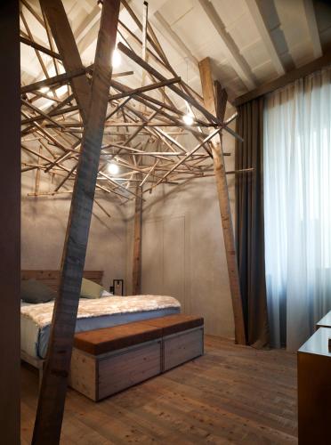 a bedroom with a bed in a room with wooden beams at Benci House in Florence
