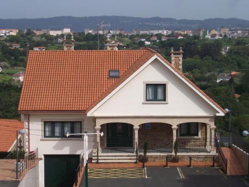 a white house with an orange roof at Val de Serantes in Ferrol