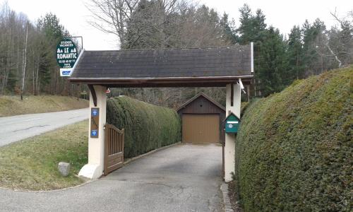 a garage with a roof on the side of a road at Romantic Studio Vacances in Labaroche