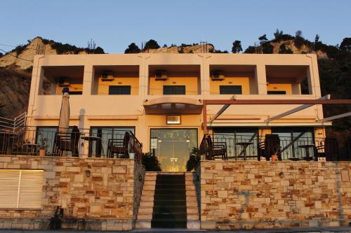 a building with a staircase in front of it at Θέα - View Appartments in Paralía Kímis