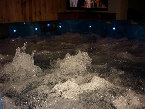 a pool of water with bubbles in it at R1 Rolléder Apartman-ház in Siklós