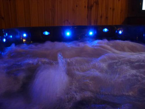 a bed covered in snow with blue lights at R1 Rolléder Apartman-ház in Siklós