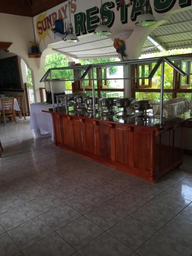 a counter with a bunch of pots and pans on it at Rayon Hotel in Negril