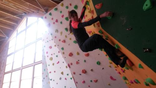 a man is on a climbing wall at Refugio La Ardilla Real in Santa Maria de Valdeón