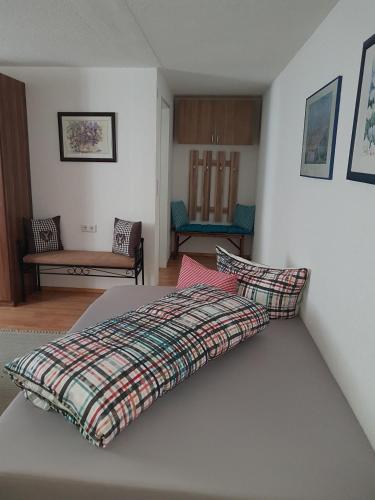 a bedroom with a bed with a blanket on it at Landhaus Ostermann in Umhausen