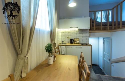 a small kitchen with a table and a dining room at Inga Vacation House in Druskininkai