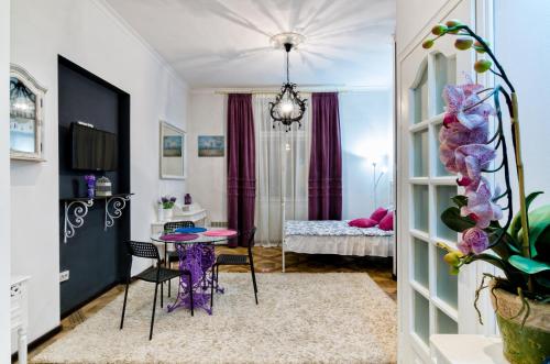 a living room with a table and a bedroom at Stylish Studio near Rynok square in Lviv