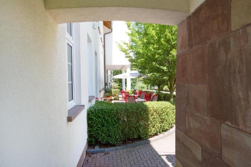 an archway leading into a yard with a patio at Hotel Montana in Guxhagen