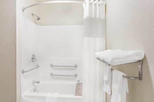 a bathroom with a white tub and a sink at SureStay Hotel by Best Western Morganton in Morganton