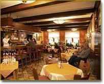 a restaurant with tables and people sitting at tables at Hotel zur Krone in Birresborn