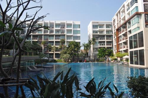 a swimming pool in the middle of two apartment buildings at 266 @The Seacraze in Hua Hin