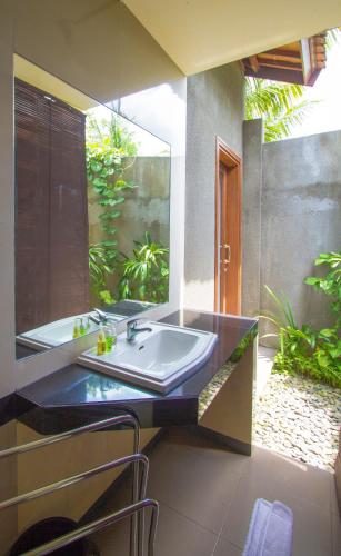 a bathroom with a sink and a bath tub at Ladera Villa Ubud in Ubud