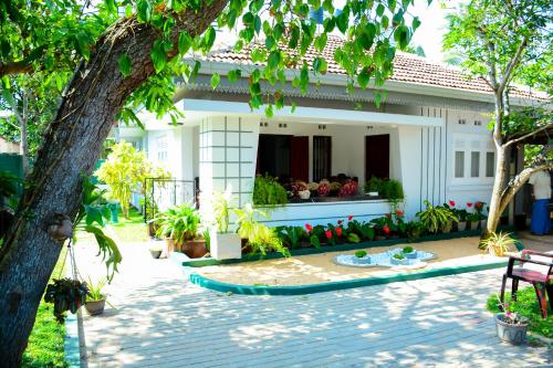 a house with a garden in front of it at Mama Beach Villa in Negombo