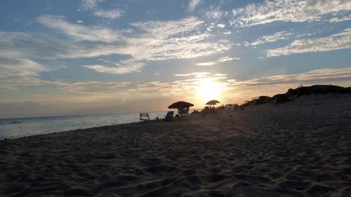 a group of people on a beach with umbrellas at Casa Marieta Ocean Park in Sauce de Portezuelo