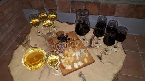 a bunch of glasses of wine on a table at Guest House Gardenia & Wine Cellar in Lagodekhi