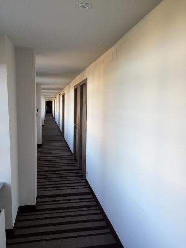 a hallway with white walls and a long corridor at Jet Hotel in Caselle Torinese