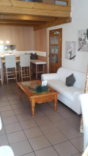 a living room with a couch and a coffee table at Ferien- und Aktivhotel Zum Arber in Bodenmais