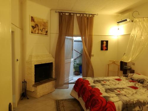 a bedroom with a bed and a fireplace at terra e mare in Collemeto