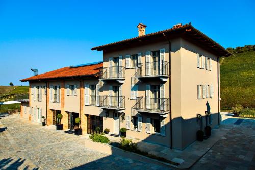 a large building with a red roof at Réva Resort in Monforte dʼAlba