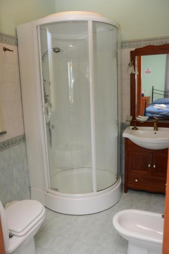 a bathroom with a shower and a toilet and a sink at B&B Villa San Leonardo in Mascali