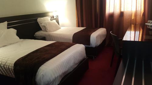 Postel nebo postele na pokoji v ubytování Numidien Hotel