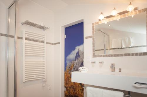 a bathroom with a sink and a mirror at Gröbl-Alm in Mittenwald