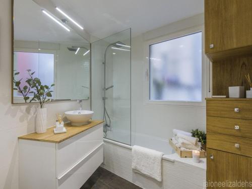 a bathroom with a sink and a glass shower at Center Pamplona Apartment in Pamplona
