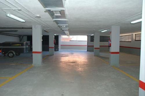 an empty parking garage with columns and a parking lot at Hostal Los Coronales in Madrid
